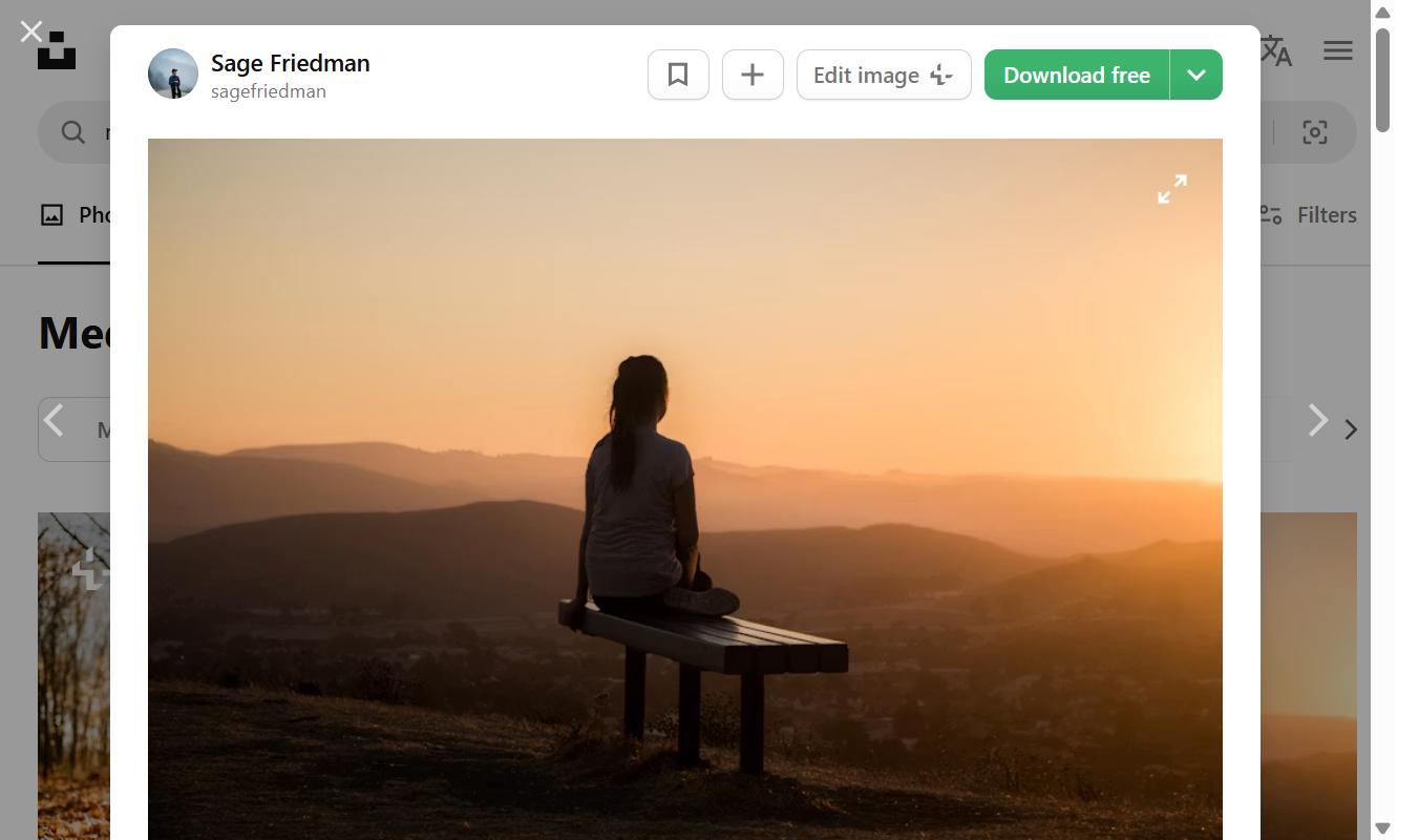 What Happens to Your Mind and Body When You Finally Slow Down 1 Woman meditating on a bench watching a peaceful sunset over mountains