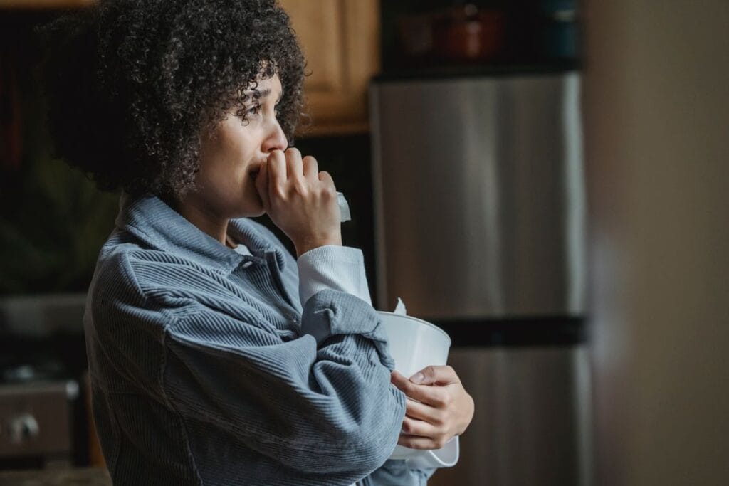 woman sitting alone looking anxious — what happens to your nervous system after a toxic relationship