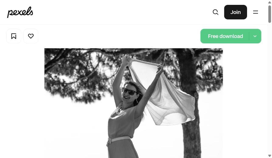 Woman joyfully raising her arms in freedom outdoors - stop people-pleasing and live for yourself