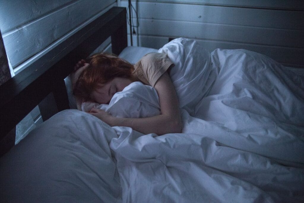 woman awake in bed overthinking at night — how to stop overthinking at night