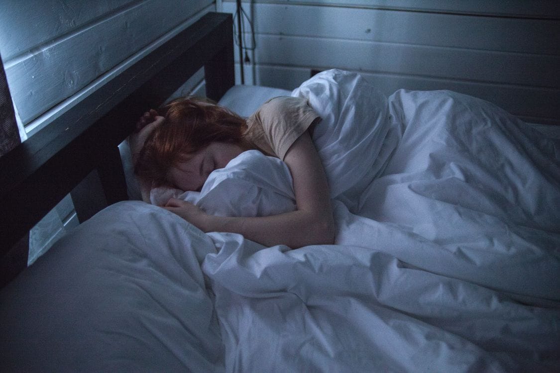 woman awake in bed overthinking at night — how to stop overthinking at night